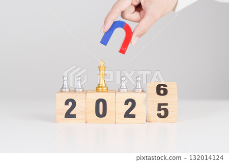 hand holding magnet and pulling man chess figure from the crowd employee with 2026 Year block. Human resource management, Recruitment, Teamwork, strategy, toxic people and leadership Concepts hand holding magnet and pulling man chess figure from the crowd employee with 2026 Year block. Human resource management, Recruitment, Teamwork, strategy, toxic people and leadership Concepts 132014124