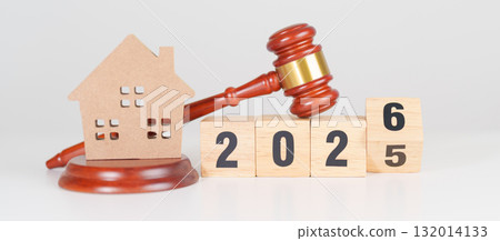 2025 end year to Happy New Year 2026 with small toy house model with gavel justice hammer on desk in courthouse. Real Estate Law, Home Insurance, property Tax, Auction and Bidding concepts 132014133