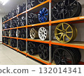 A lot of car rims on the shelf for sale 132014341