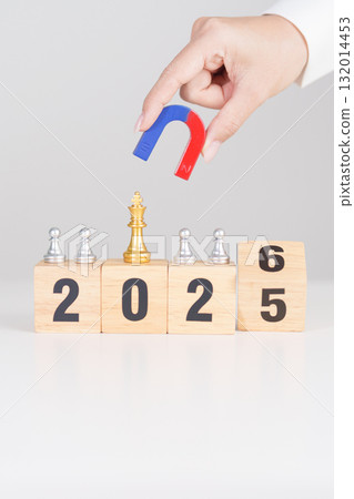 hand holding magnet and pulling man chess figure from the crowd employee with 2026 Year block. Human resource management, Recruitment, Teamwork, strategy, toxic people and leadership Concepts 132014453
