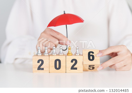Happy New Year 2026 with hand holding red umbrella cover people chess. life Insurance, health medical, leadership, protection, safety and New year holiday Concepts 132014485