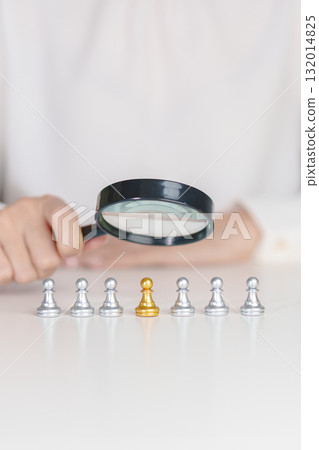 Businesswoman hand holding magnifying glass for recruiting leader man chess from crowd of employees.Human resource management, Recruitment, Teamwork, hiring and leadership Concepts Businesswoman hand holding magnifying glass for recruiting leader man chess from crowd of employees.Human resource management, Recruitment, Teamwork, hiring and leadership Concepts 132014825