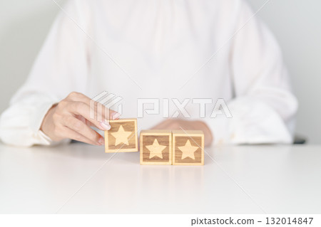 hand show Star block. Customer choose rating for user reviews. Service rating, ranking, customer review, satisfaction, evaluation and feedback concept hand show Star block. Customer choose rating for user reviews. Service rating, ranking, customer review, satisfaction, evaluation and feedback concept 132014847