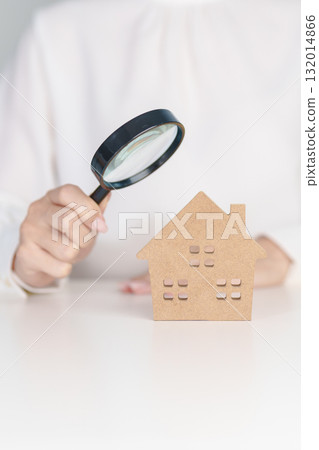 Hand hold magnifying glass over House model. mortgage, immovable assets investment, Property Inspection, Searching for real estate, purchase and rental home concept Hand hold magnifying glass over House model. mortgage, immovable assets investment, Property Inspection, Searching for real estate, purchase and rental home concept 132014866