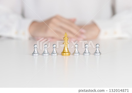 Hand hold golden chess pawn pieces or leader businessman stand out of crowd people of silver men. leadership, business, team, teamwork and Human resource management concept Hand hold golden chess pawn pieces or leader businessman stand out of crowd people of silver men. leadership, business, team, teamwork and Human resource management concept 132014871