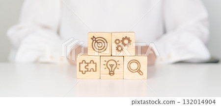 wood block with business goal, strategy, target, mission, action, objective, teamwork, research and idea concept 132014904