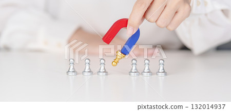 Hand use magnet pulling to golden chess pawn pieces or leader businessman stand out of crowd people of silver men. leadership, business, team, teamwork, unique and Human resource management concept 132014937