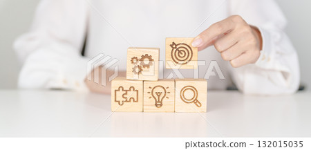 wood block with business goal, strategy, target, mission, action, objective, teamwork, research and idea concept 132015035