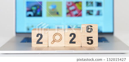 2025 end year to Happy New Year 2026 block magnifying glass icon against laptop background. Hiring, recruitment, job, jobless SEO, Search Engine Optimization and New Year concepts 132015427