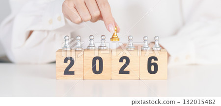 hand holding man chess figure from the crowd employee with 2026 Year block. Human resource management, Recruitment, Teamwork, strategy, toxic people and leadership Concepts 132015482