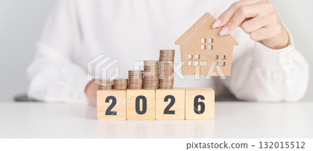 Happy New Year 2026 with house model and Coins stack. real estate, Home loan, tax, investment, mortgage, financial, savings and New Year Resolution concepts Happy New Year 2026 with house model and Coins stack. real estate, Home loan, tax, investment, mortgage, financial, savings and New Year Resolution concepts 132015512