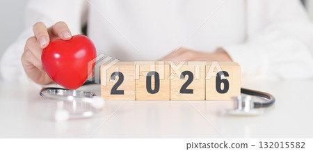 Happy New Year 2026 with Stethoscope of doctor and heart shape on table. health care, Insurance, Wellness and medical concepts 132015582