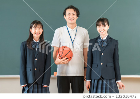 教室裡,黑板前,一位男老師拿著籃球,一位女學生穿著西裝 教室裡,黑板前,一位男老師拿著籃球,一位女學生穿著西裝 132016472