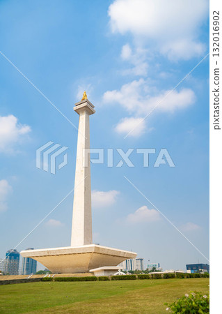 Jakarta's Monas (Independence Monument) - Indonesia's symbol towering against the blue sky Jakarta's Monas (Independence Monument) - Indonesia's symbol towering against the blue sky 132016902