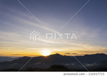 Landscape of Morning Mist with Mountain Layer. mountain ridge and clouds in rural jungle bush forest Landscape of Morning Mist with Mountain Layer. mountain ridge and clouds in rural jungle bush forest 132017715