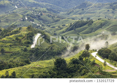 Landscape of Morning Mist with Mountain Layer. mountain ridge and clouds in rural jungle bush forest 132017729