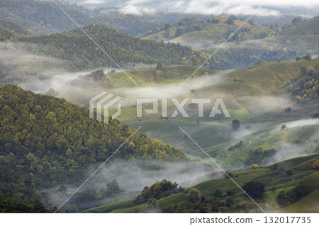 Landscape of Morning Mist with Mountain Layer. mountain ridge and clouds in rural jungle bush forest Landscape of Morning Mist with Mountain Layer. mountain ridge and clouds in rural jungle bush forest 132017735