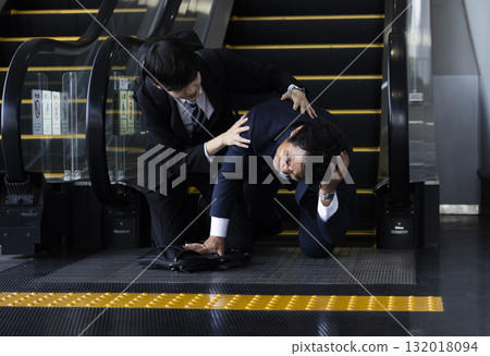 Businessman falling down on an escalator 132018094