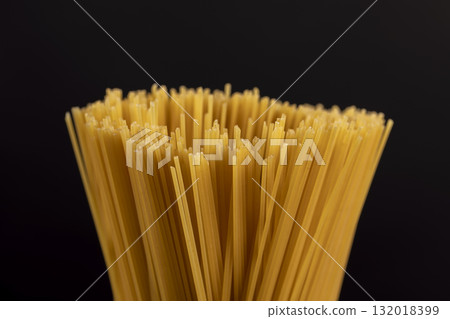 thin, long, hard yellow spaghetti made from durum flour using water , not cooked , hard spaghetti made from high-quality wheat flour, close up thin, long, hard yellow spaghetti made from durum flour using water , not cooked , hard spaghetti made from high-quality wheat flour, close up 132018399