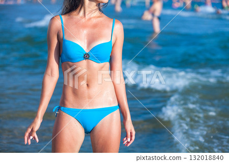 Sexy gorgeous woman with beautiful slim body is posing on the sea or ocean beach, summer holidays concept Sexy gorgeous woman with beautiful slim body is posing on the sea or ocean beach, summer holidays concept 132018840