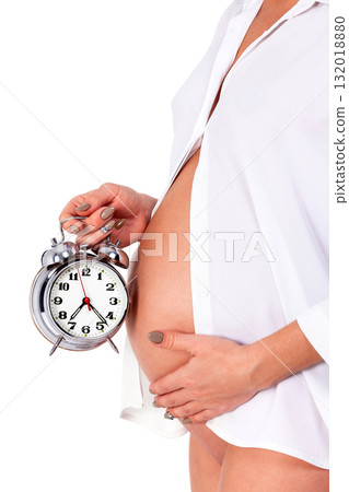 Closeup shot of pregnant woman who holds an alarm clock. Isolated on white background 132018880