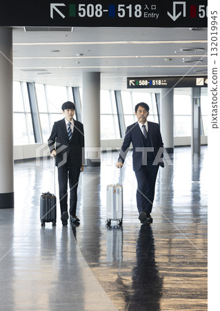 Businessman pulling a suitcase 132019945