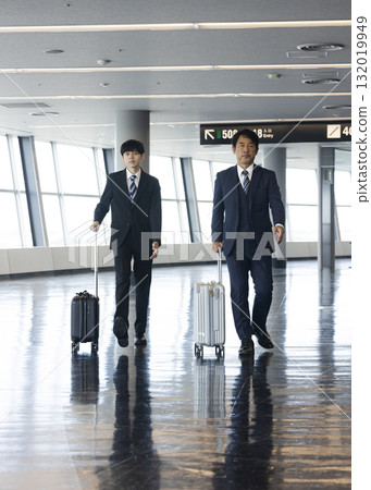 Businessman riding escalator 132019949