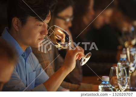 Man Tasting White Wine by Smelling 132020707
