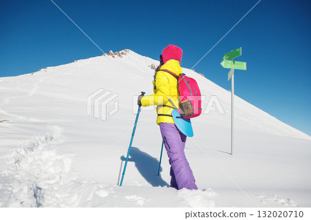 Determined Female Trekker Observes Snowy Peak Ahead on Bright Winter Day 132020710