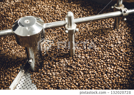 Overhead View ov Roasting Process Coffee Beans on Professional Mixing Roaster Machines. 132020728