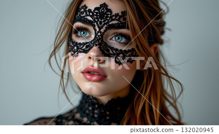 A young woman with striking blue eyes, wearing a black lace mask that covers her entire face, leaving only her eyes visible A young woman with striking blue eyes, wearing a black lace mask that covers her entire face, leaving only her eyes visible 132020945
