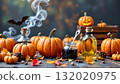 A festive autumnal setup with a collection of pumpkins, Halloween decorations, and seasonal items arranged on a wooden surface 132020975