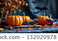 An autumnal Halloween setting with three pumpkins of varying sizes arranged in front of a spooky background featuring bat silhouet 132020978
