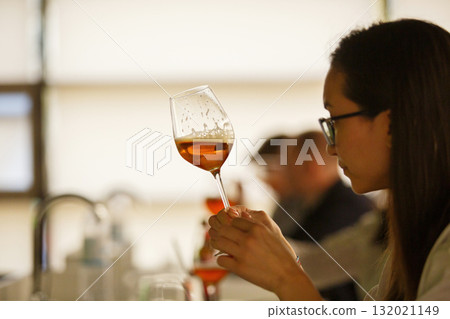 Professional Sommelier Woman Tasting Beer, Looking it Color, Rate it Density and Strength Being at Advanced Training Courses for Professionals in Field of Alcoholic Beverages 132021149