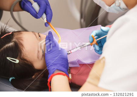 Little Child Girl Receiving Anesthetic Injection in Dental Chair 132021291