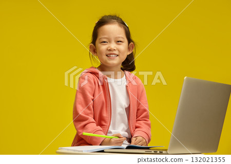 Cheerful Korean Toy with Bright Smile Engages in Learning sitting over isolated background. Sprightly Chinese Child Enjoys Study Time 132021355