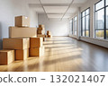 Moving cardboard boxes in empty sunny room 132021407