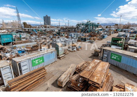 Aerial view of a vast metal scrap yard under a partly cloudy sky. Industrial waste awaits processing in this recycling hub 132022276