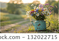 Rustic Flower Vase in Sunlit Garden.Turquoise watering can with wildflowers on grass, glowing in warm sunlight. Perfect for spring, nature, and romantic themes. 132022715