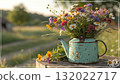 Rustic Flower Vase in Sunlit Garden.Turquoise watering can with wildflowers on grass, glowing in warm sunlight. Perfect for spring, nature, and romantic themes. 132022717