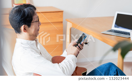 Male man who operates a smartphone 132023444