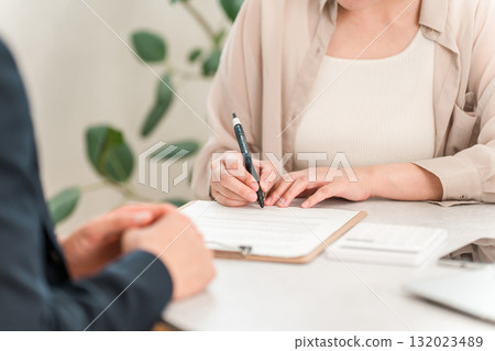Female customer and businessman signing contract, pledge, document 132023489