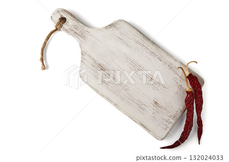 Painted white wooden board with hot red pepper pods isolated on white background 132024033