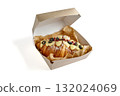 croissant topped with blueberry glaze and strawberry crumble in a cardboard lunch box 132024069