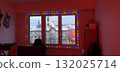 Snow-covered Strasbourg seen through a window with twinkling lights, mobile photo. Cozy winter scene ideal for illustrating holiday, festive, cityscape, and seasonal atmosphere. 132025714