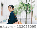 A young lady walking in the city 132026095