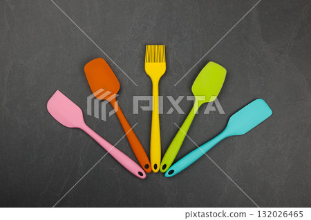 Silicone culinary spatulas and brushes on black 132026465