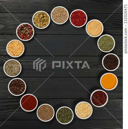 Circle of assorted spices in bowls 132026471