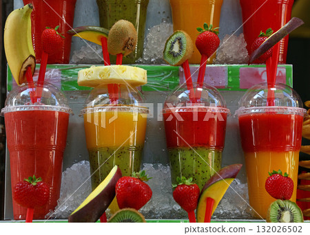 Fresh fruit juices and smoothies on retail shelf 132026502