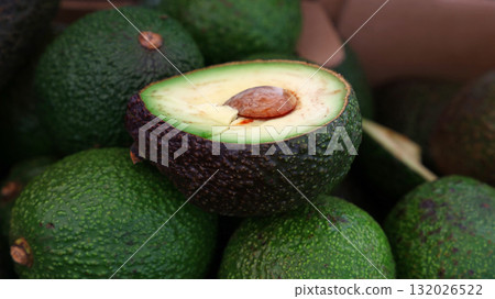 Fresh green and purple avocado on retail display Fresh green and purple avocado on retail display 132026522